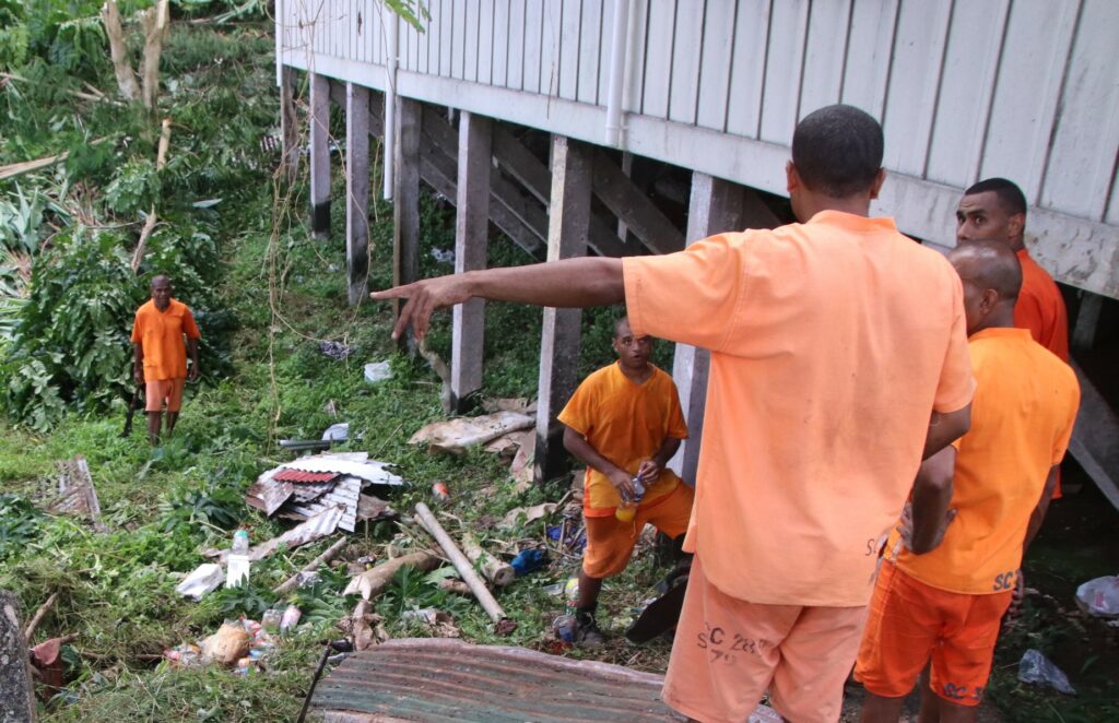 Inmates and Officers clean up old historical site